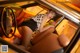 A woman sitting in the driver's seat of a yellow car.