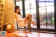 A woman sitting in a rocking chair in front of a window.