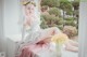 A woman in a wedding dress sitting on a window sill.