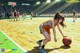 A woman dribbling a basketball on a basketball court.