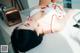 A woman laying on top of a white table.